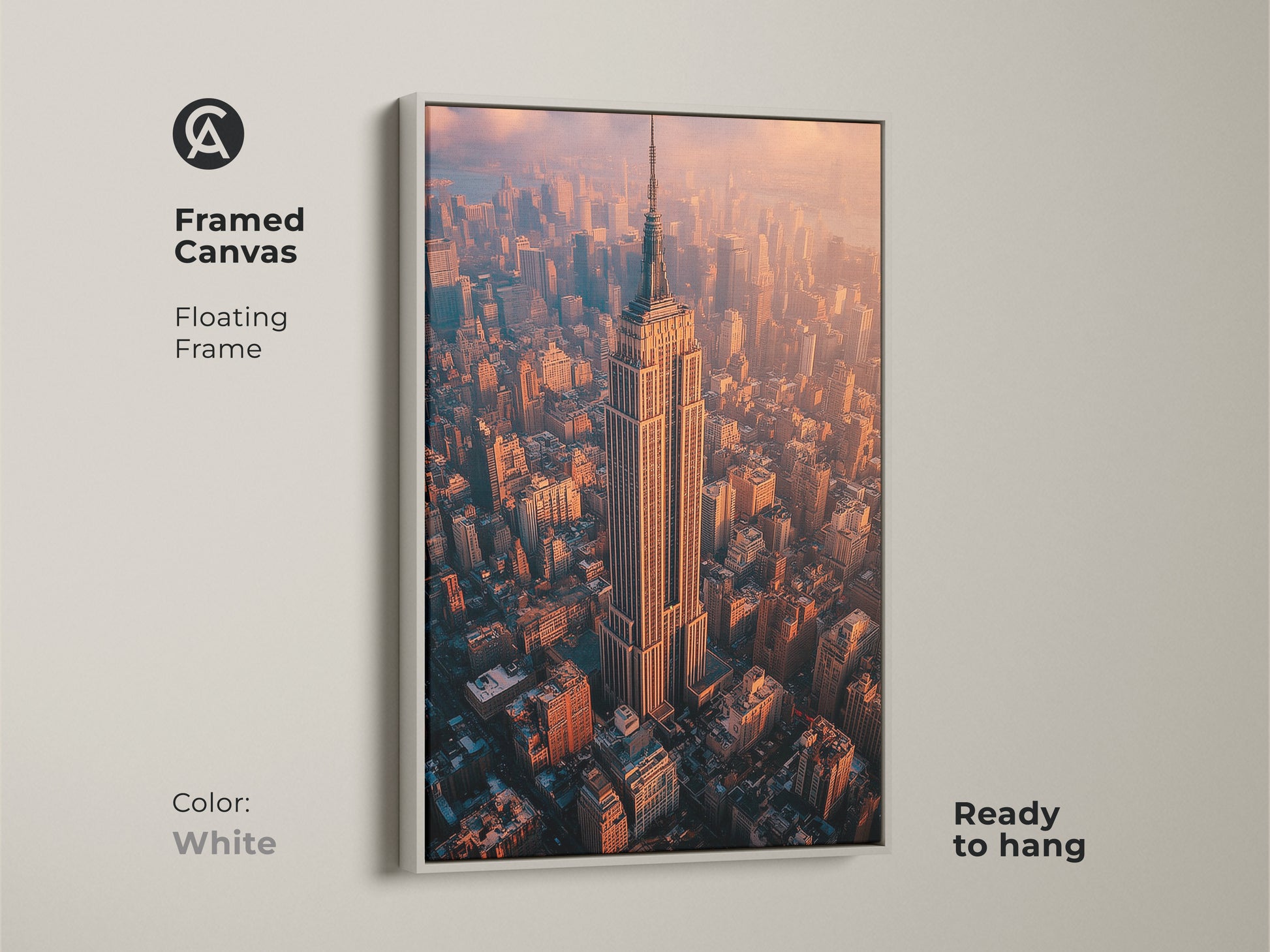 Framed canvas floating frame in white featuring the Empire State Building. Ready to hang aerial NYC photography print. This contemporary artwork showcases a golden hour cityscape. It brings the grandeur of New York City to your space. Perfect for urban photography enthusiasts and as office wall art. This modern piece is ideal for home office decor.