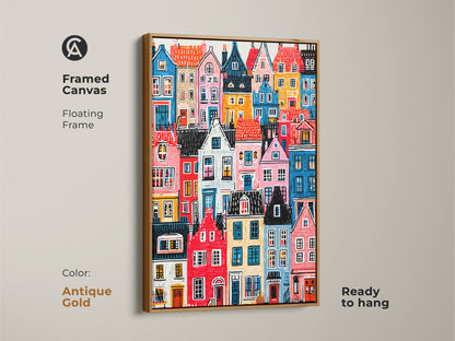 Framed canvas displaying colorful houses art. It has an antique gold floating frame. The artwork is ready to hang. This vibrant cityscape print brings a touch of elegance to any room. Stylish art.