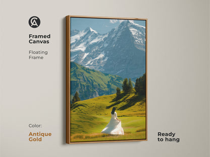 This canvas art print displays a mountain landscape with snowy peaks and a woman in a white dress. This framed canvas has a floating frame with an antique gold color. This wall art is ready to hang. A perfect piece for modern living room art enhancing contemporary bedroom decor.