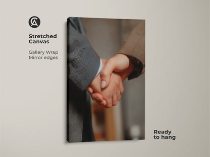 Close-up of a stretched canvas handshake art print. Gallery wrap with mirror edges. It's ready to hang. This business partnership canvas art represents corporate success. Ideal modern office decor. A professional gift that embodies teamwork and achievement.