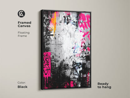 Framed canvas of graffiti artwork with a black floating frame. The painting includes striking pink and orange colors on a black and silver backdrop. Ready to hang this canvas enhances any room.