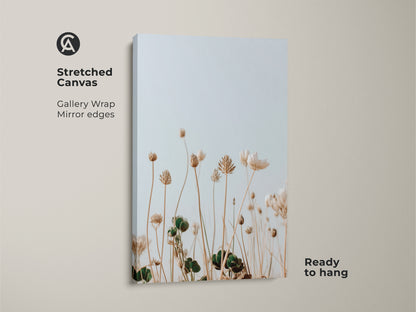 Stretched canvas featuring minimalist wildflower art. A boho botanical canvas adds neutral charm to any room. Cream floral art creates a serene atmosphere. Light blue wildflowers enhance nature wall art. Perfect as a housewarming gift for plant lovers. This gallery-wrapped artwork is ready to hang.