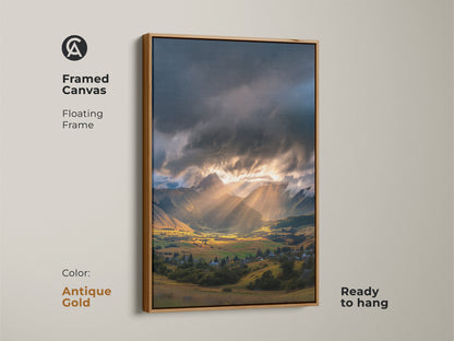 Framed canvas of a mountain valley art print. Golden hour landscape with dramatic sun rays. Floating frame in antique gold color. A peaceful valley art for a serene landscape print in any home setting.