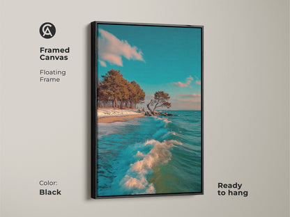 This Framed Canvas features an ocean wave and coastal trees. A teal sky completes this coastal landscape artwork. The floating frame is in black. It is ready to hang. This piece enhances beach-themed decor and brings a sense of calm to any room.