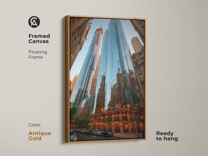 Framed canvas with blue cityscape artwork. The modern skyscraper canvas features a floating antique gold frame. This contemporary architecture decor is ready to hang. Perfect for business office wall art. A housewarming cityscape print.