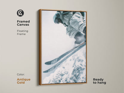 Framed canvas artwork of a skier jumping. The artwork has an antique gold floating frame. This adds a touch of elegance. Ready to hang. Perfect for adding a sporty yet classy touch to your decor.