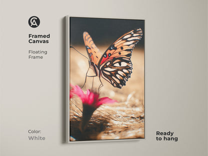 Framed canvas with a floating white frame shows an orange butterfly. This nature photography artwork is ready to hang. The realistic insect print is a great addition to boho interiors. A colorful and detailed piece for nature lovers. Perfect bedroom art.
