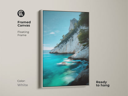 White framed canvas featuring coastal cliff canvas print of azure ocean. This ocean seascape wall art brings turquoise blue beach art. The framed floating frame is ready to hang and perfect for modern beach art decor