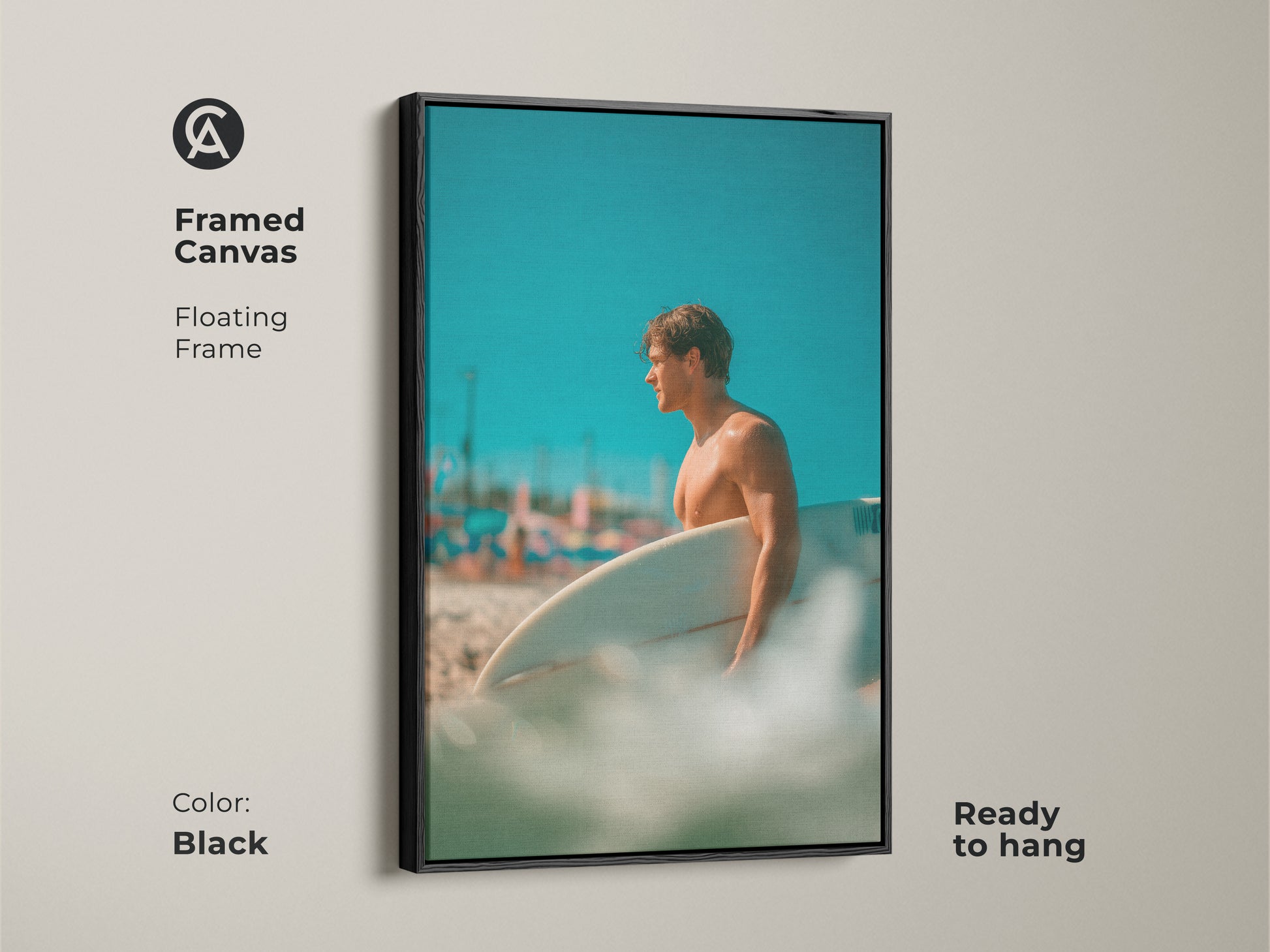 Framed canvas artwork of a surfer. The floating frame is black. The image shows a man holding a surfboard on a beach. This framed art is ready to hang and will look great in any room.