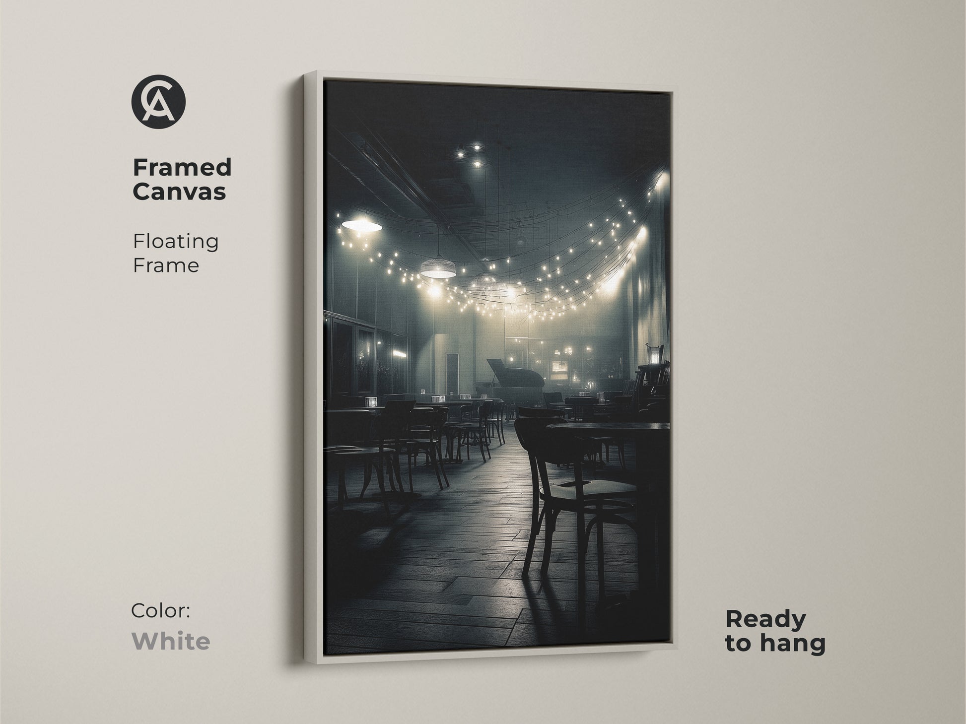 This framed canvas displays a monochrome cafe scene. The clean white floating frame highlights the artwork. String lights illuminate empty tables. Ready to hang this artwork adds sophistication to your home.
