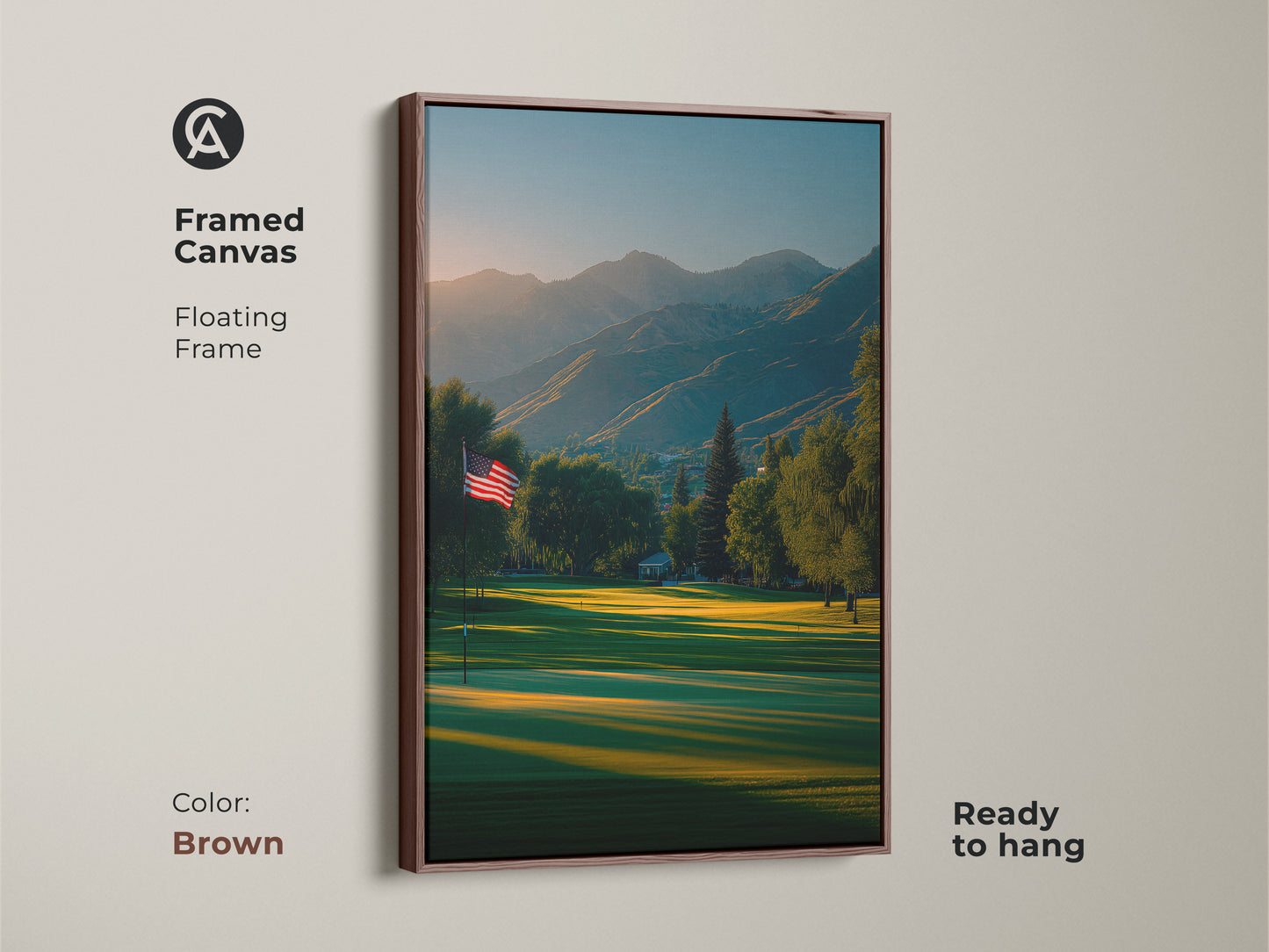 Framed canvas artwork in a brown floating frame features a golf course. The American flag is visible. Mountains complete the picturesque scene. Elevate your home with this ready-to-hang piece. Buy now for a classic touch.