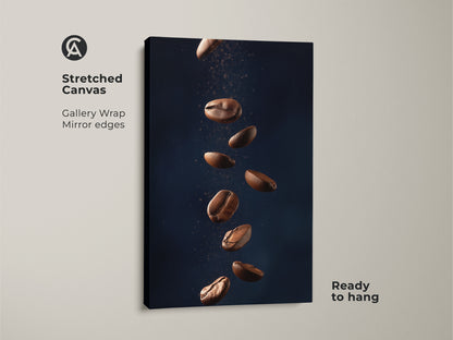 Stretched canvas gallery wrap featuring abstract coffee art. This minimalist kitchen wall art showcases falling coffee beans. It's a modern Tan and Dark Blue art print. The contemporary coffee decor is ready to hang adding style to any room.