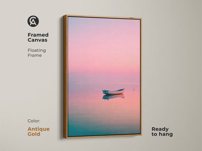 Framed canvas art featuring a boat on calm water. The floating frame is antique gold. This coastal artwork is ready to hang. A peaceful and serene fine art print for your home.
