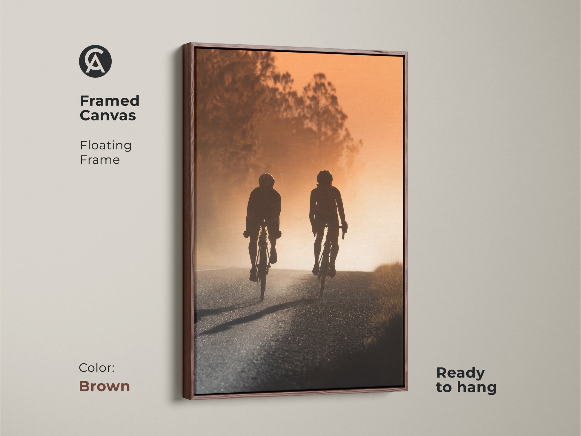 Framed canvas print with a brown floating frame displaying a cycling couple on a road. This modern landscape art adds a touch of sports adventure to any room. A unique housewarming gift for cyclists. Perfect for modern office art.
