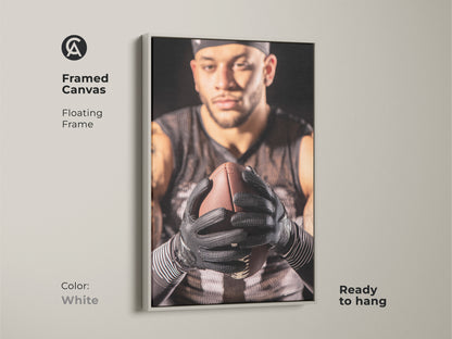 White framed canvas print of an American Football player. The floating frame adds a modern touch to the sports artwork. Ready to hang in a home gym or office. This athlete portrait is a perfect gift for football fans. Add masculine decor to your man cave.