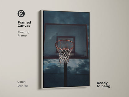 Framed canvas with a floating frame featuring basketball art. The dark blue sky art adds a moody touch to any space. Great sports poster print or gift for him basketball. The artwork has a white frame.