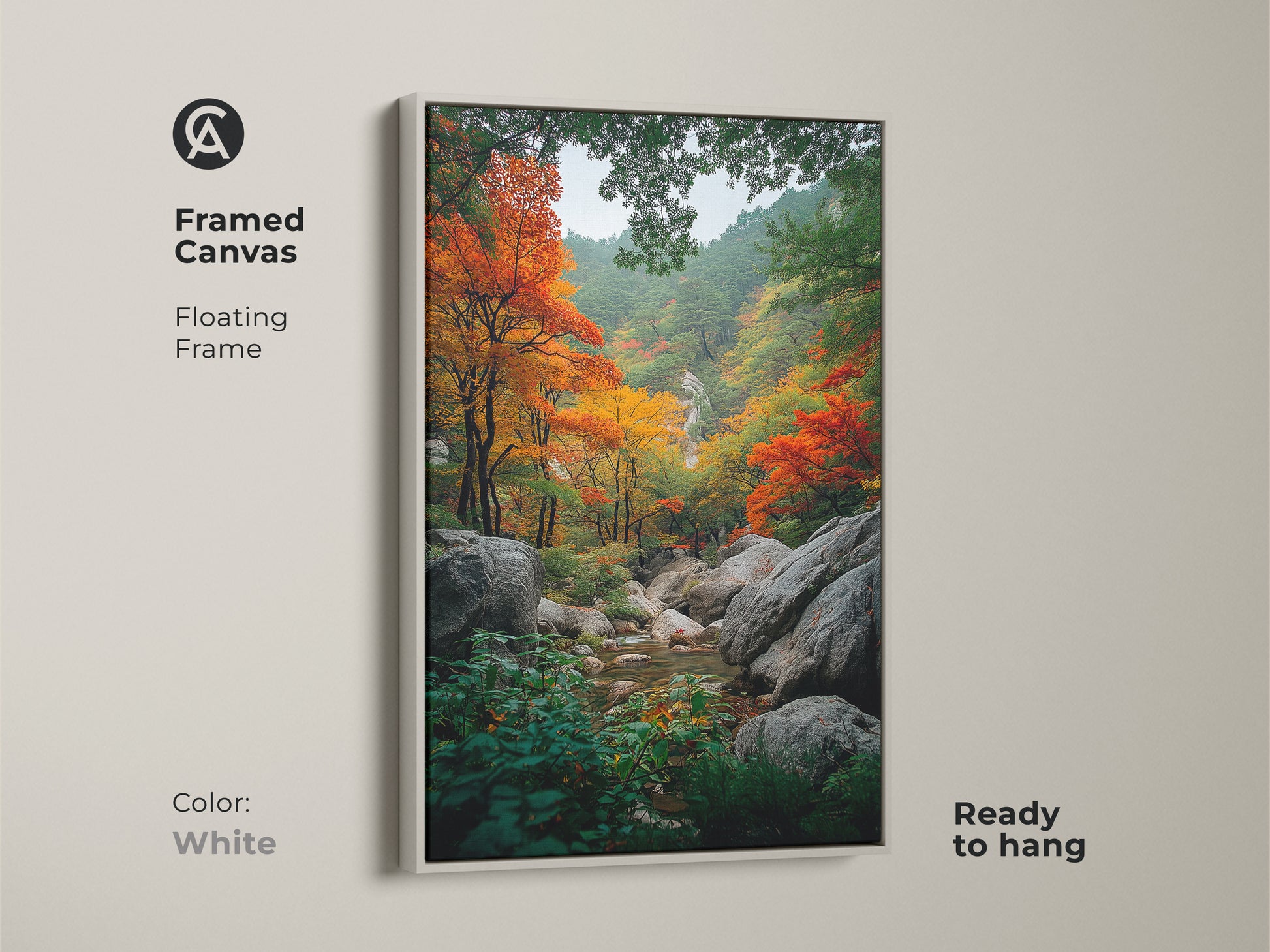 Framed canvas of autumn forest artwork. White floating frame enhances the vibrant fall foliage. The art captures nature's beauty with orange and red leaves. A tranquil stream flows through the rocky landscape. Ready to hang in your home.