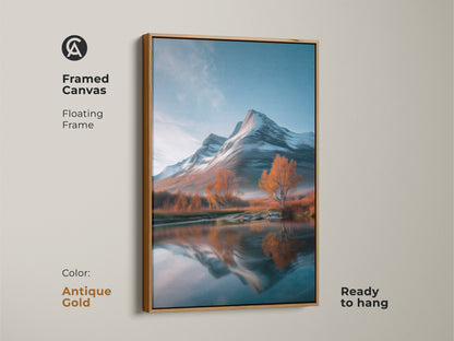Antique gold framed canvas showcasing a mountain landscape. This rustic nature art print is ready to hang. The artwork captures snow-covered mountains autumn trees and a reflective lake. The gold frame enhances the cozy cabin decor bringing the serene outdoor scene indoors with its blue white and orange artwork.