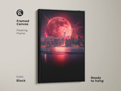 Framed canvas art featuring a surreal cityscape under a vibrant red moon. The floating black frame adds a sleek contemporary touch. This fantasy night sky print is ready to hang and enhances any space such as a modern office decor or an ethereal bedroom.