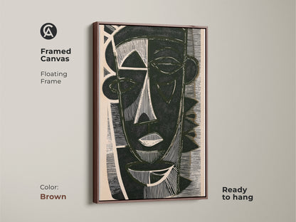 Framed canvas featuring dark green abstract face art with a floating brown frame. This unique face artwork is ready to hang. A bold linocut design great as residential wall art.