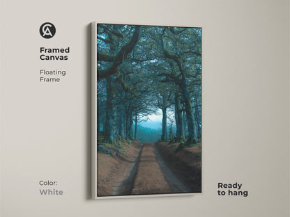 A framed canvas with a floating frame showcases an emerald teal tree tunnel canvas. This dark academia landscape artwork is ready to hang. The white frame offers a clean look to this forest path artwork.