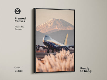 Framed canvas art of a Boeing 747 taking off with Mount Fuji in the background. The travel photography canvas has a floating black frame. This contemporary aviation art is ready to hang. Featuring blue gold and beige tones this piece adds a worldly touch to any home or workspace. Perfect gift for pilots.