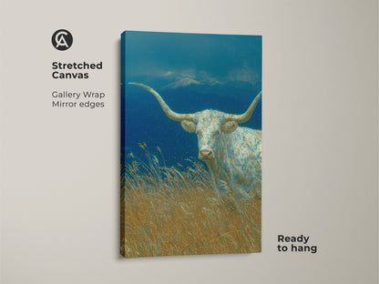 This stretched canvas showcases the White Longhorn artwork. The gallery wrap and mirrored edges give a modern seamless look. The longhorn stands proudly in a field with mountains in the background. Ready to hang this piece adds sophistication to your decor.