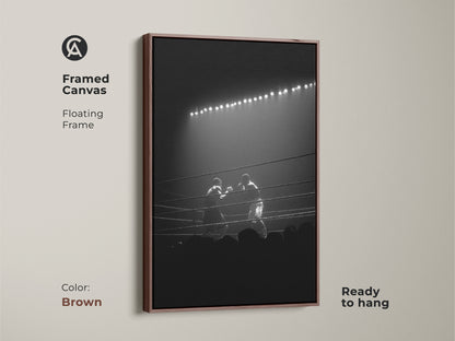 A framed canvas in brown displays black and white boxing artwork. It includes a floating frame and arrives ready to hang. This vintage boxing art print suits any space a fighter may occupy.