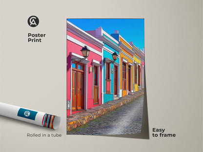 This is a poster print of cartoonish travel artwork easy to frame. It shows a colorful European street scene with hot pink sky blue and teal houses. Ideal for eclectic home decor. This cityscape art print on museum-quality paper makes a vibrant addition to any wall. A unique gift for travel lovers seeking bohemian style decor.