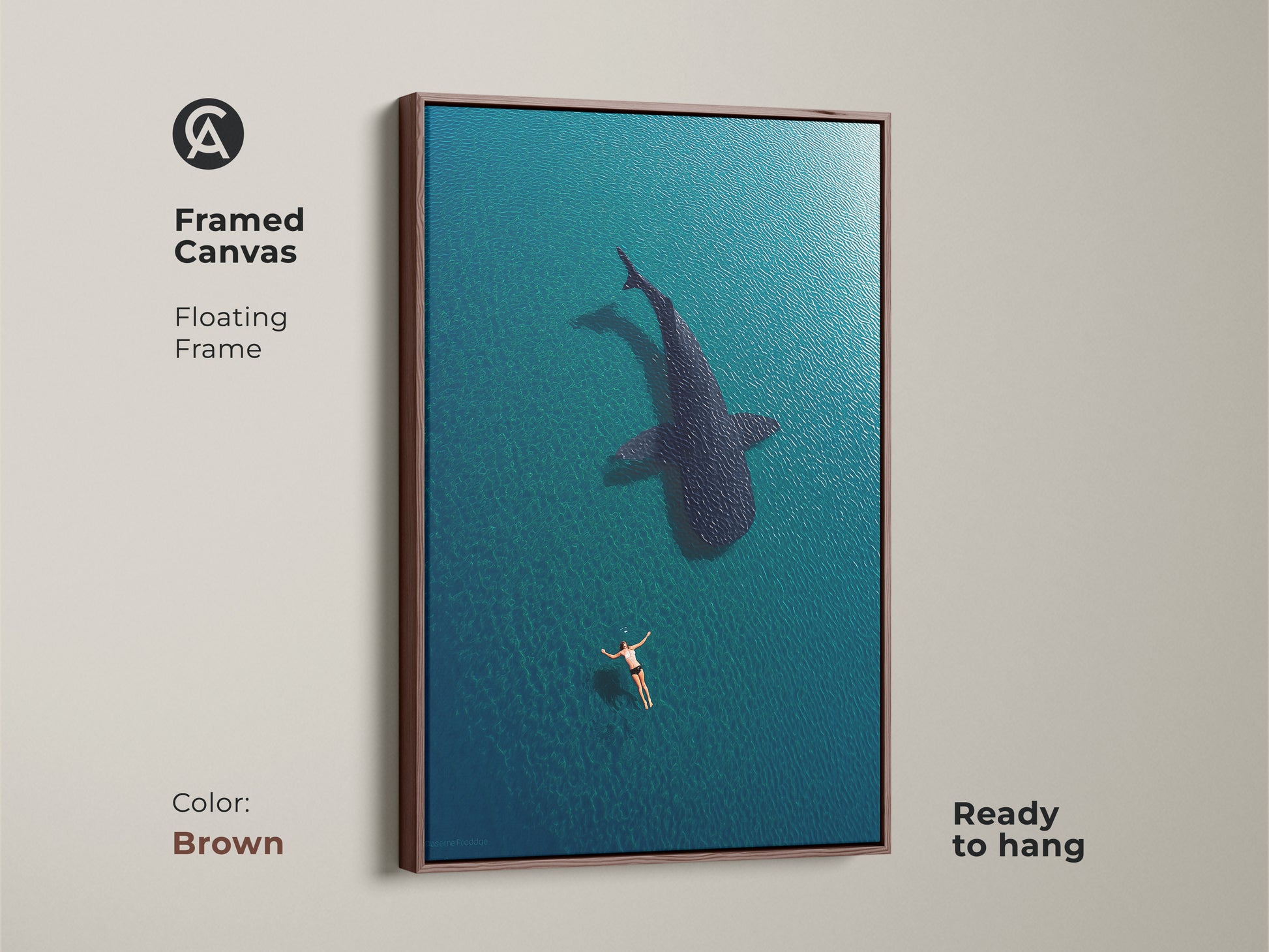 Brown framed canvas featuring aerial ocean art of a swimmer and whale shark. This ready-to-hang coastal artwork brings a warm touch to your home. The deep blue turquoise tones create a calming underwater scene perfect for any beach house or nautical decor.