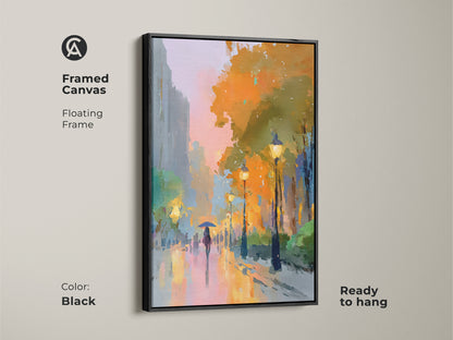 Framed canvas art in a black floating frame. This expressive cityscape features a rainy street scene with a person under an umbrella. The artwork is ready to hang adding a sophisticated touch. The oranges and yellows glow.