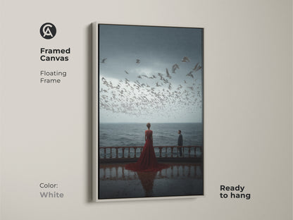 A white framed canvas features couple art that is ready to hang. The floating frame enhances the coastal artwork. This romantic anniversary gift shows a couple watching seagulls. It's ideal for home decor. The surreal cinematic canvas print adds a fresh touch to any room.
