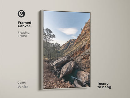 Framed canvas art of a Rocky Mountain landscape with a white floating frame. This rustic wall decor features sky blue nature photography and gnarled trees. Ready to hang this is a perfect hiker gift. Enhance your space with this scenic mountain view.