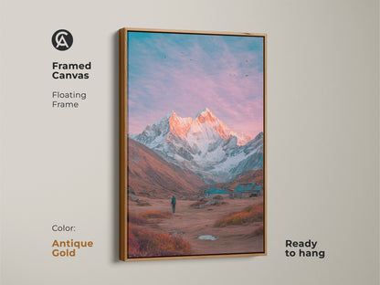 Antique gold framed canvas art of a mountain landscape. The artwork showcases a majestic mountain at sunset. A lone figure stands in the foreground. This framed canvas is ready to hang. Add a touch of warmth to your space with this mountain artwork.