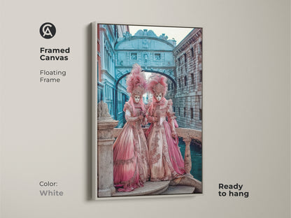 White framed canvas of Venetian Carnival Artwork. This masquerade mask wall art is ready to hang. The floating frame showcases regal pink gold teal artwork. A baroque style print for eclectic home decor.