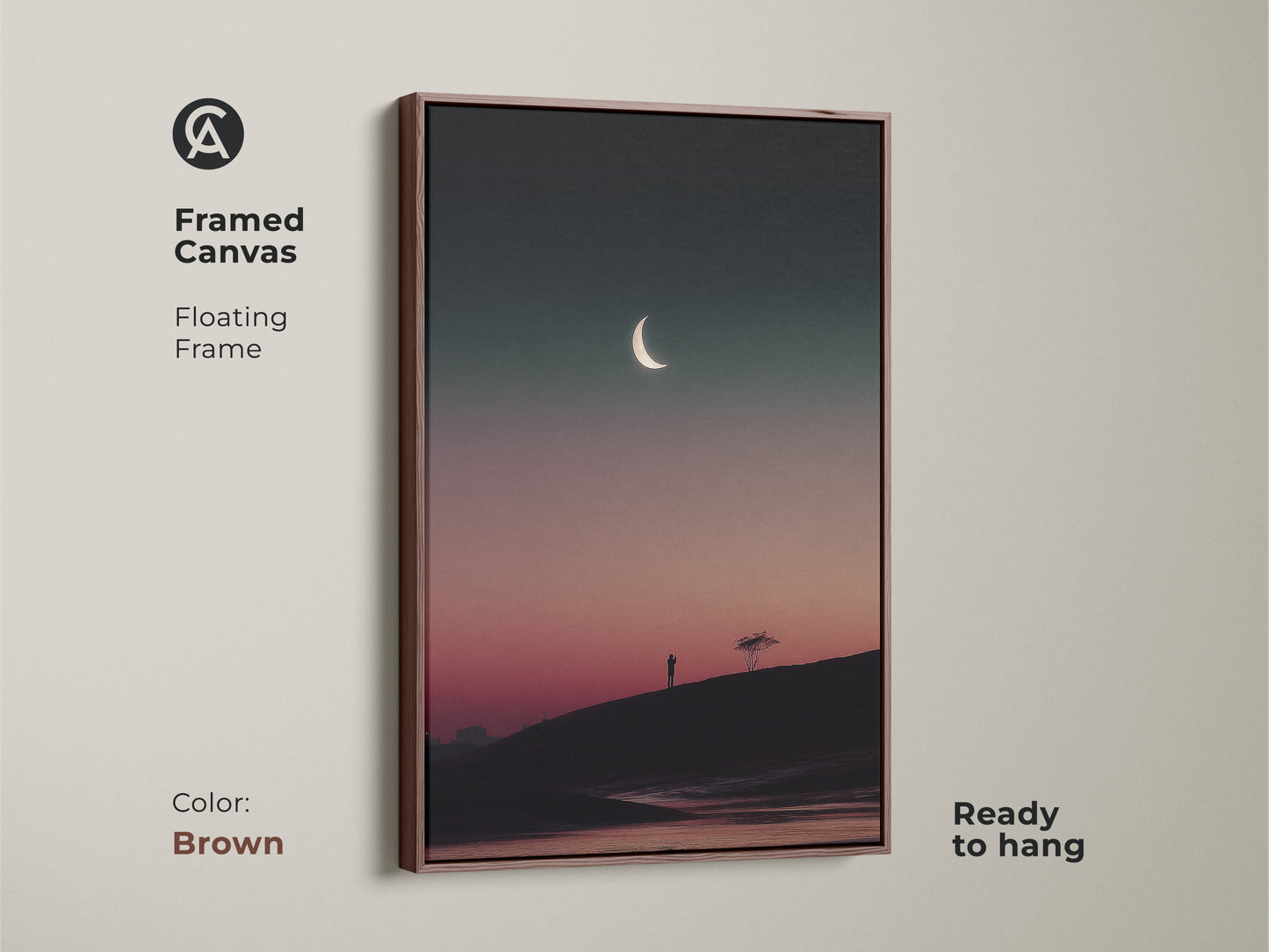 Brown framed canvas print of a minimalist landscape. This surreal moon wall art showcases a dark teal and pink gradient. The lone tree art print is ready to hang and adds an atmospheric touch. A perfect gift.