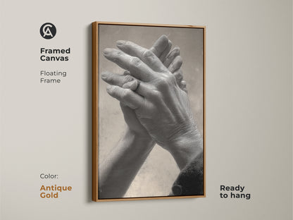 Antique gold framed canvas featuring intertwined hands. Floating frame enhances the grayscale couple art. Ideal as a thoughtful anniversary gift or contemporary bedroom decor. A timeless piece of human connection artwork.
