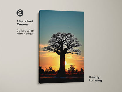 Stretched canvas of an African baobab tree at sunset. The gallery wrap and mirror edges enhance the sunset silhouette landscape print. The orange and teal tones bring a boho vibe. Ready to hang nature inspired artwork.