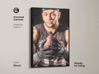 Black framed canvas showcasing an American Football player. Floating frame enhances the intense sports photography. This home gym artwork is ready to hang. Perfect man cave wall decor for sports enthusiasts. A striking athlete action portrait.