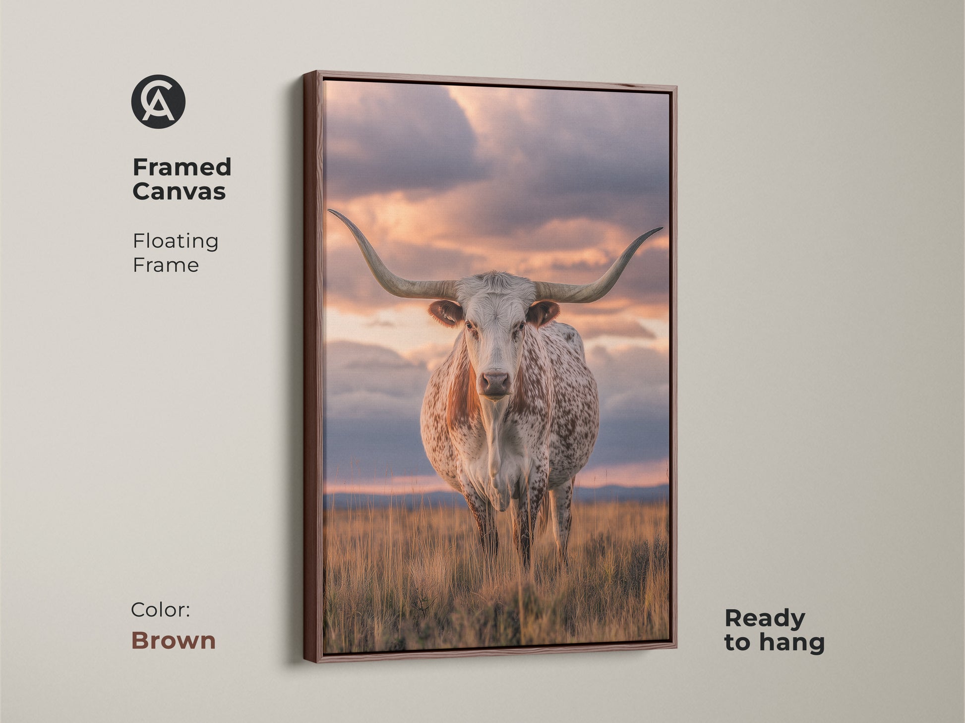 Framed Texas Longhorn canvas art with a brown floating frame. Ready to hang this wildlife wall decor brings the west to your home. This savanna sunset landscape is perfect for farmhouse decor. A photorealistic animal print adds a rustic touch.