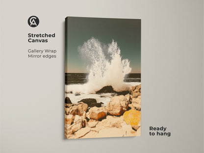 Stretched canvas featuring a teal ocean wave art print. The gallery wrap has mirrored edges. Ready to hang coastal seascape wall art captures a crashing wave on a rocky shore. This beach house canvas art piece brings the ocean indoors adding coastal charm.