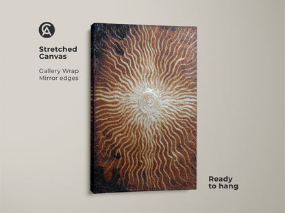 Stretched canvas of a bronze gold abstract spiral. The sunburst artwork features a gallery wrap with mirrored edges. Ready to hang this textured piece will add modern eclectic flair. It makes a thoughtful gift for art collectors.