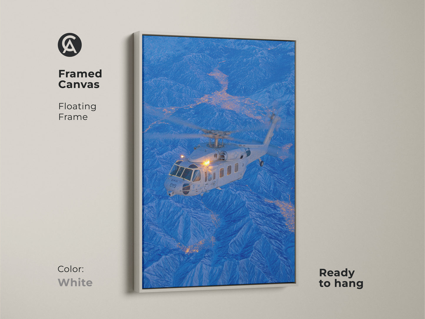 Helicopter flying over a city nestled in the mountains in this framed canvas art. The white floating frame offers a clean modern look. This aviation-themed artwork is ready to hang and will brighten up any space with its crisp design.