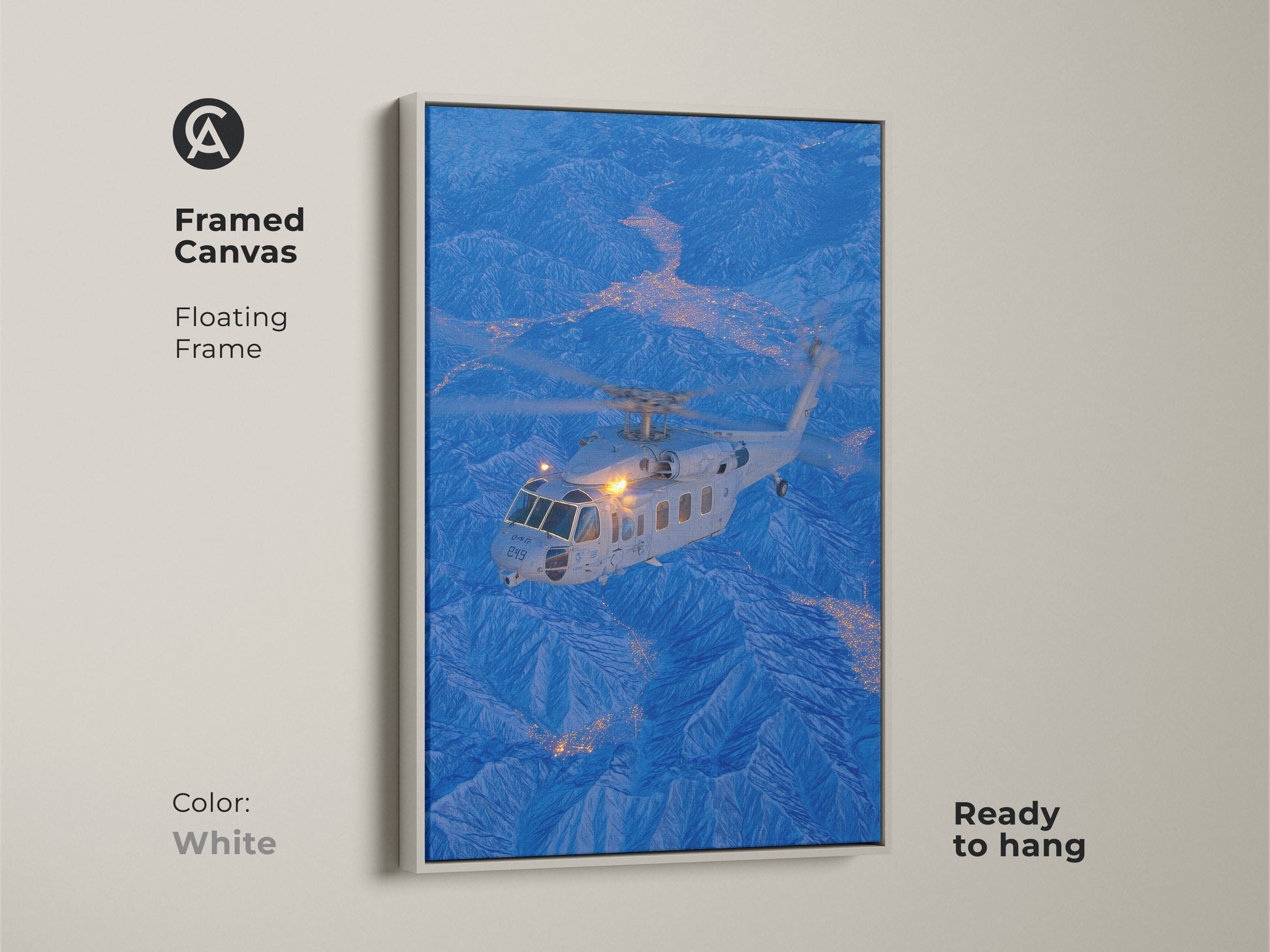 Helicopter flying over a city nestled in the mountains in this framed canvas art. The white floating frame offers a clean modern look. This aviation-themed artwork is ready to hang and will brighten up any space with its crisp design.