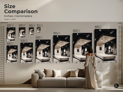 Size comparison of Brutalist architecture canvas art print. Black and white artwork next to sofa gives a sense of scale. Loft wall decor that complements contemporary office decor. Explore modern minimalist art for housewarming gifts. Discover your perfect fit today!