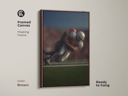 Framed canvas showcasing a dynamic football tackle with a floating brown frame. This photorealistic sports action wall art is ready to hang. Ideal for man cave decor this football artwork makes a great gift for any sports fan. Add a compelling piece of modern art to their collection.