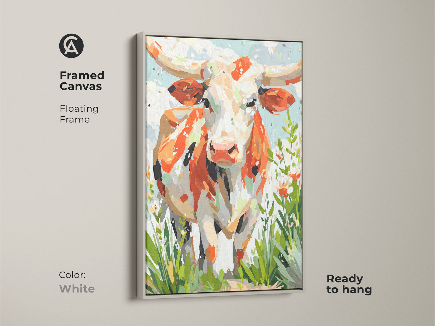 A white framed canvas displays longhorn cow artwork. The floating frame gives a modern touch. The artwork combines orange white and cream tones. Green accents add life. This canvas is ready to hang.