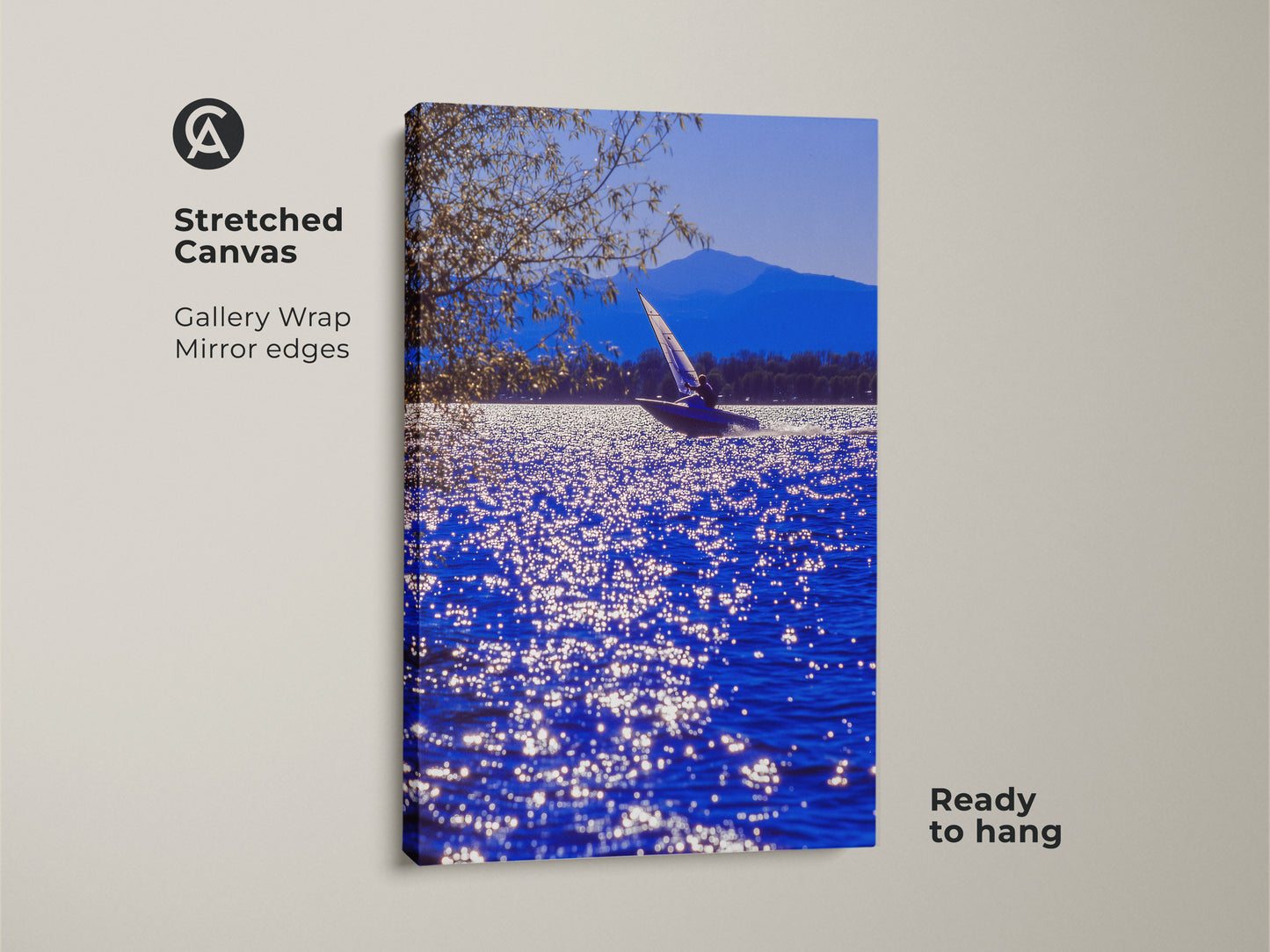 A stretched canvas art print shows a sailboat on blue water. A mountain range is in the background. This gallery-wrapped canvas has mirrored edges. This coastal artwork arrives ready to hang for easy display.