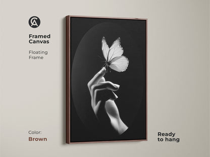 A framed canvas displays monochrome butterfly artwork. Its floating frame enhances the minimalist hand art. Black and white wall decor is ready to hang. The artwork is a thoughtful nature lover gift. A contemporary choice for bedroom art. Insect macro print suits an elegant home. This fine art canvas enhances a minimalist living room. This butterfly wall hanging provides a modern office art touch