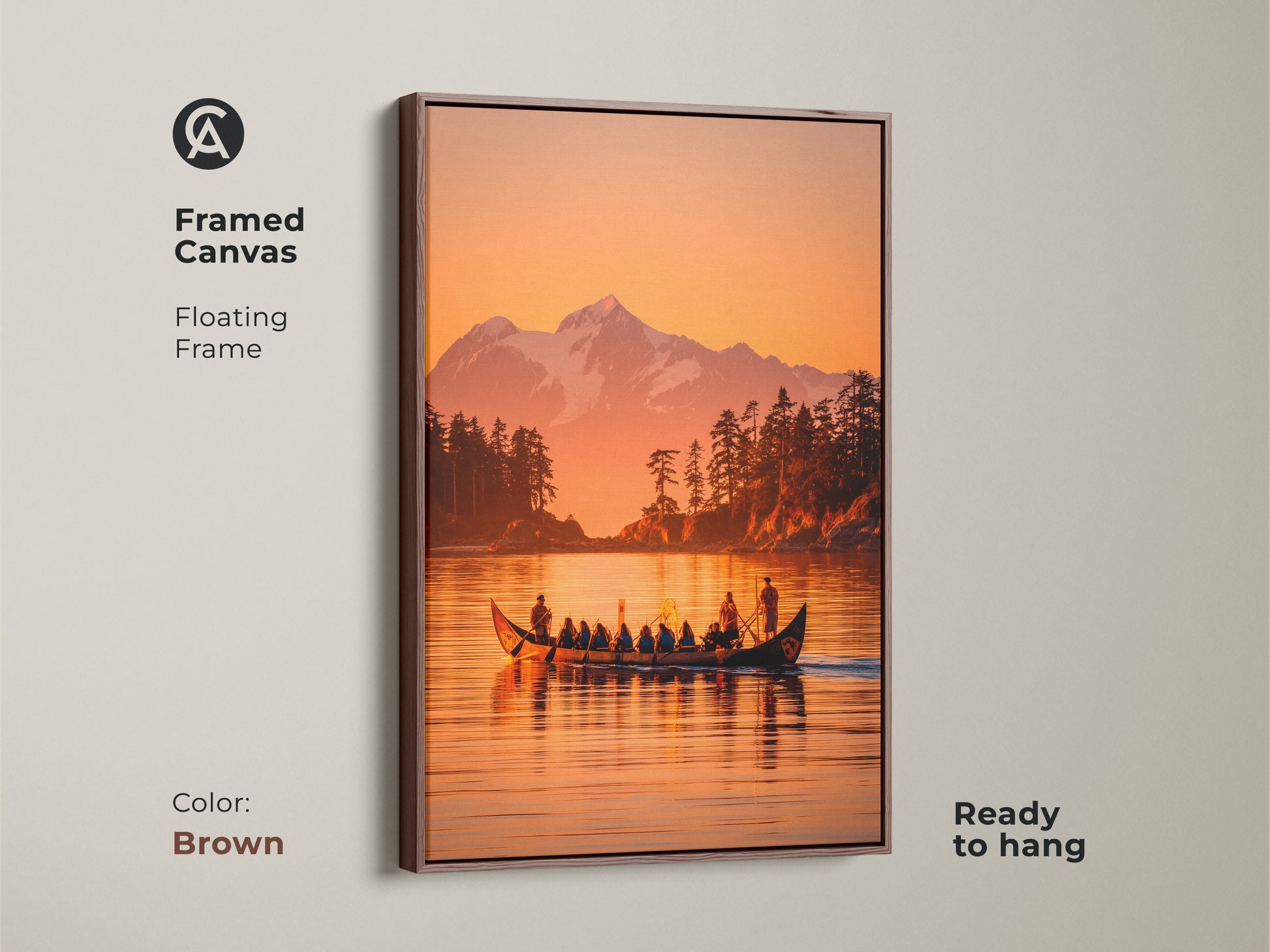 Framed canvas artwork highlighting a canoe on a lake. The artwork has a beautiful mountain and forest in the background. The piece is framed with a brown floating frame. This ready-to-hang art brings a warm and natural feel to your home.